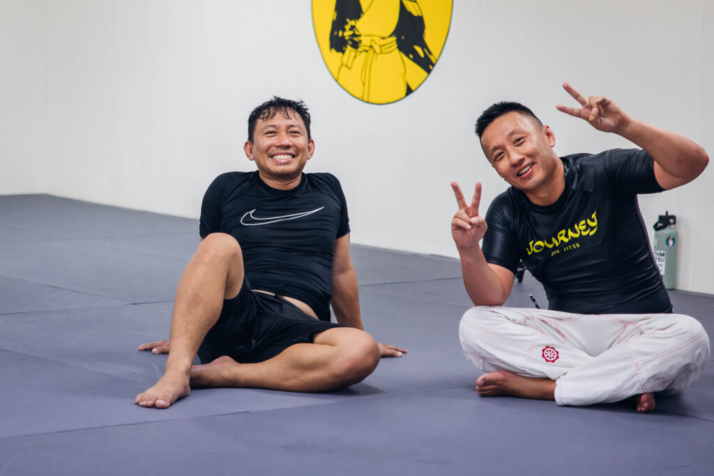 Journey Jiu-Jitsu Members smiling to the camera, after a nogi class at Journey Jiu-Jitsu.