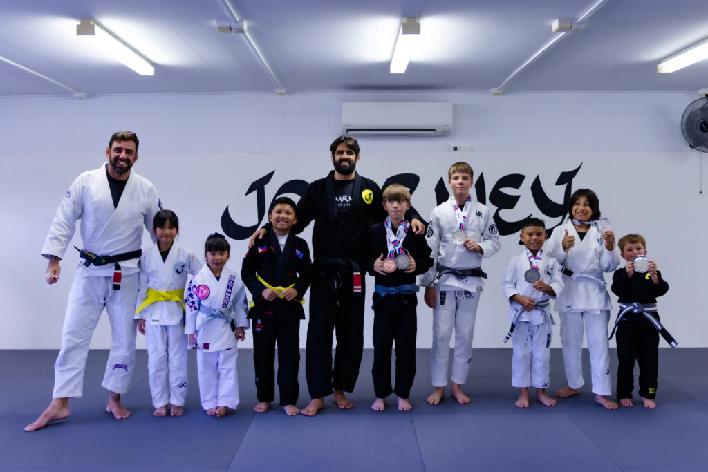 group photo after a brazilian jiu jitsu competition on gold coast. the photo was taken at journey jiu jitsu.